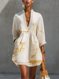 Vestido corto estampado en marfil y dorado con escote en V y encaje de crochet
